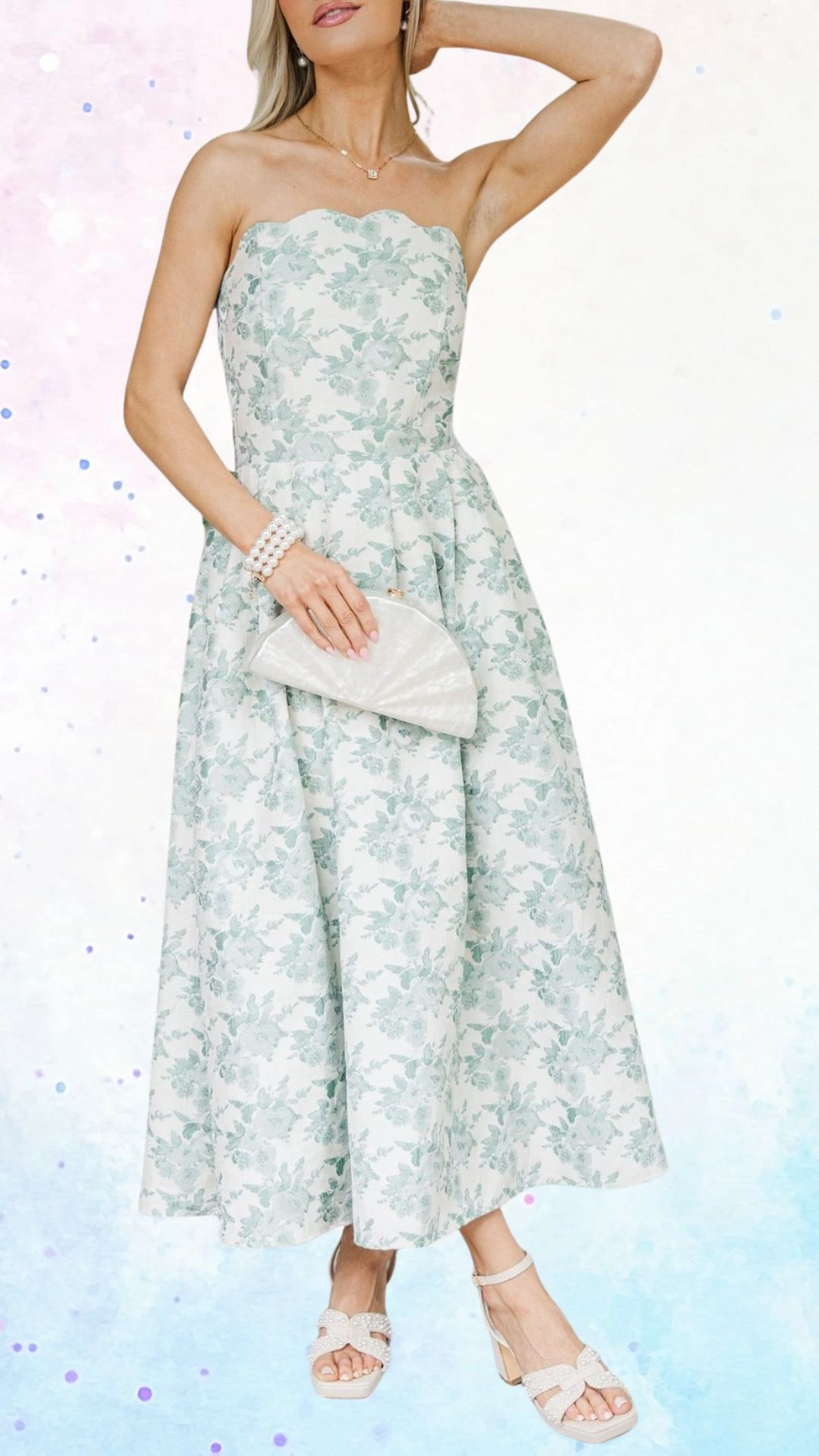 The outfit features a strapless, A-line dress made from textured fabric with a delicate floral pattern in soft mint green against a light background. The scalloped neckline adds an elegant touch, while the full skirt, complemented by a matching pearl bracelet and a stylish white clutch, enhances the outfit's celebratory essence for a baby shower. The ensemble is finished with strappy block-heeled sandals adorned with decorative bows.