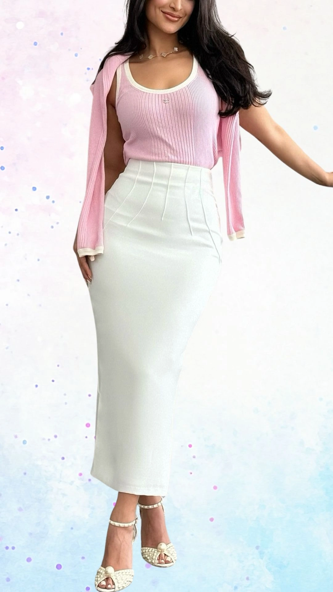 The outfit features a fitted white midi skirt crafted from a smooth fabric, accentuated by soft pleats for added elegance. Paired with a light pink ribbed tank top and a matching cardigan draped over one shoulder, the ensemble radiates a cheerful and sophisticated vibe, ideal for a baby shower celebration. The look is completed with stylish pearl-embellished sandals for a touch of charm.