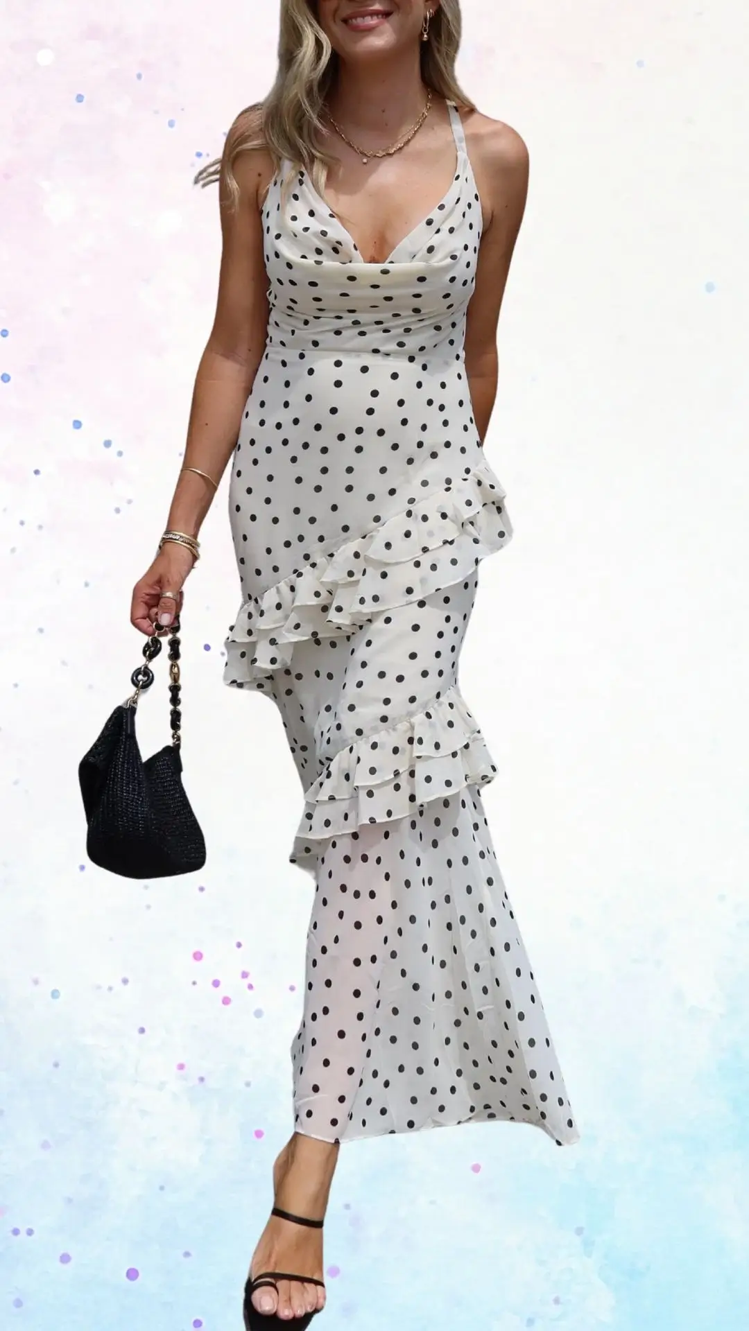 The outfit features a white dress with black polka dots, made from a lightweight, flowing fabric that adds a playful yet elegant touch. It has a flattering V-neckline and thin adjustable straps, with layered ruffle details along the hemline, enhancing its celebratory feel. The dress is complemented by strappy black sandals and a stylish black handbag, perfect for a baby shower.