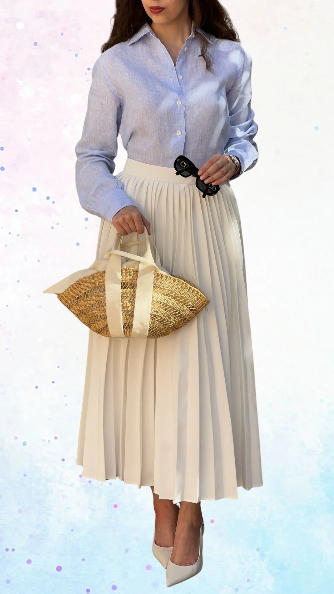 The outfit features a light blue button-up shirt made of soft fabric with long sleeves and a classic collar, paired with a flowing cream pleated skirt that adds a touch of elegance. Accessories include a straw handbag with cream straps and stylish beige high heels, creating a refined look suitable for a baby shower celebration. The combination of soft colors and textures conveys a cheerful and festive atmosphere.