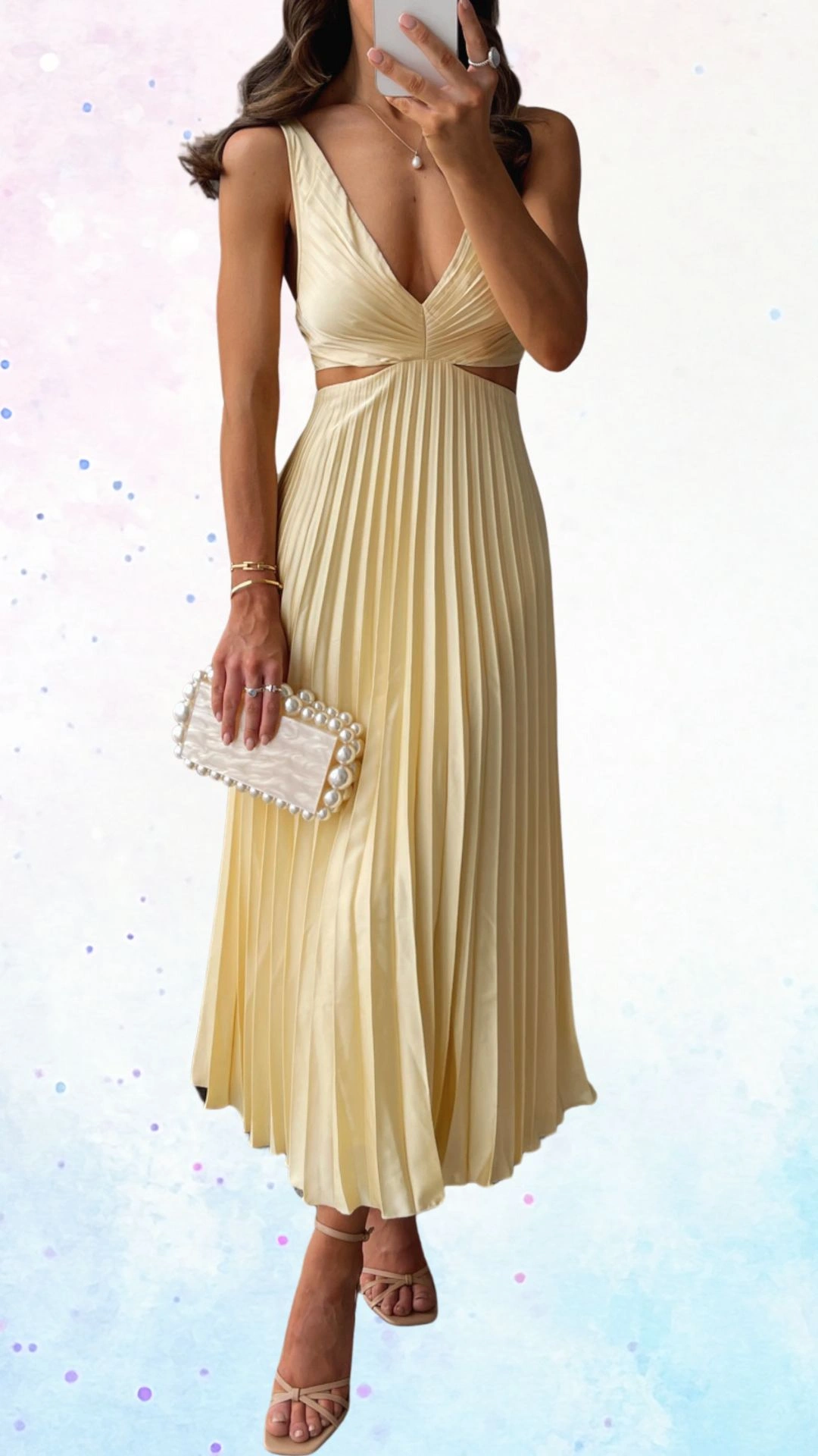 This elegant baby shower guest outfit features a flowing, pleated midi dress in a soft pale yellow shade, made from a smooth, lightweight fabric. The dress has a deep V-neckline and cut-out details at the waist, complemented by thin straps and a soft drape that enhances its graceful shape, while the wearer accessorizes with a pearl-embellished clutch and strappy nude sandals.