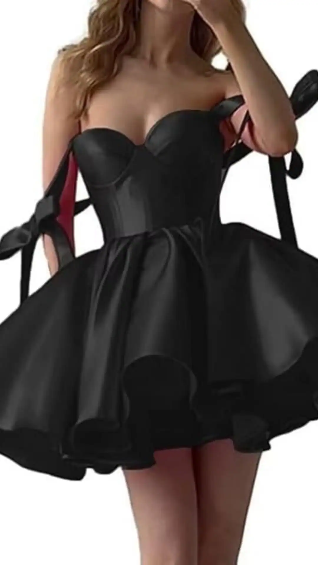 This stunning black homecoming dress features a fitted, corset-style bodice with dramatic ribbon straps, leading to a voluminous skirt with a playful flared hem. Crafted from a smooth, sleek fabric, it exudes a bold and trendy vibe, making it perfect for a formal event or school dance, tailored specifically for teenage girls.