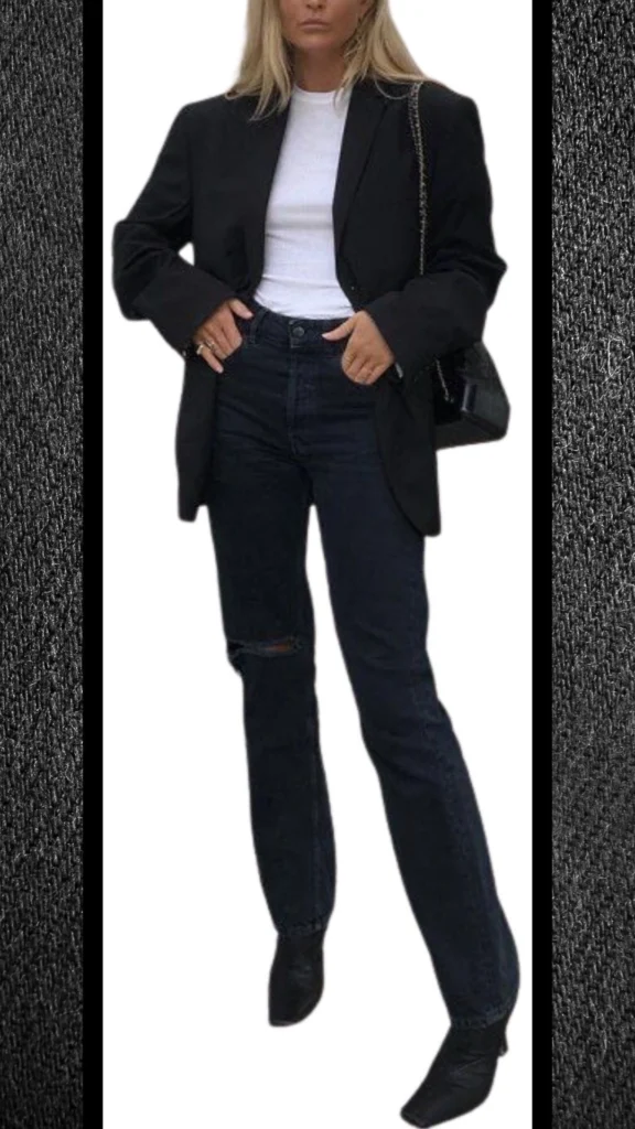 The outfit consists of high-waisted black jeans with a distressed knee detail, paired with a snug white long-sleeve top. A tailored black blazer adds sophistication, complementing the sleek, layered look, while black pointed ankle boots provide a chic finish. The combination of different textures and shades creates an elegant and trendy appearance for cooler months.