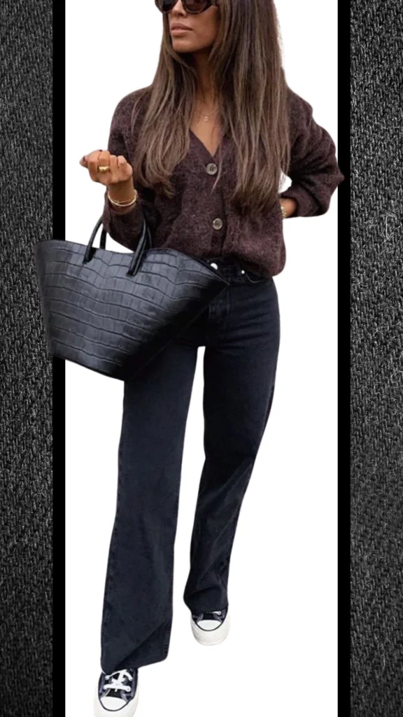 The outfit features a warm, textured dark brown cardigan with buttons, paired with fitted black jeans that have a subtle sheen, creating a sleek silhouette. The look is completed with stylish black sneakers and a structured black handbag that showcases a crocodile texture, adding a touch of sophistication ideal for winter.