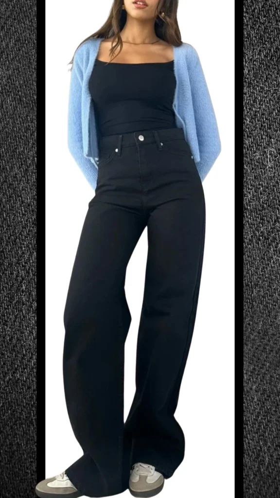 The outfit features high-waisted black jeans with a smooth, structured fabric that offers a sleek silhouette, complemented by a fitted black tank top. A soft, light blue cardigan provides a cozy contrast in texture, while stylish sneakers in neutral tones add a casual touch suitable for winter. The ensemble balances warmth and style, perfect for cooler months.