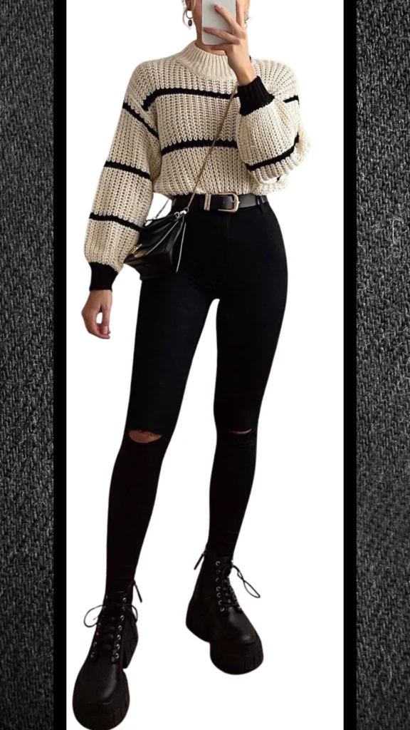 The outfit features a cozy, cream and black striped knit sweater with a loose fit and ribbed cuffs, paired with form-fitting black high-waisted jeans that have stylish ripped detailing at the knees. Complements include chunky black platform boots and a small black crossbody bag, creating a balanced and chic winter look. The textures of the knit and denim, along with the monochromatic palette, enhance visual appeal while ensuring warmth.