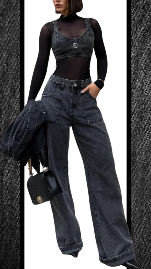 A stylish winter outfit featuring high-waisted black jeans with a relaxed fit, paired with a fitted black mesh long-sleeve top and a denim crop top overlay adorned with a circular clasp. Complemented by a coordinating black denim jacket and a quilted black handbag, the ensemble showcases a mix of textures and shades of deep charcoal, creating a chic and modern look suitable for cooler months.