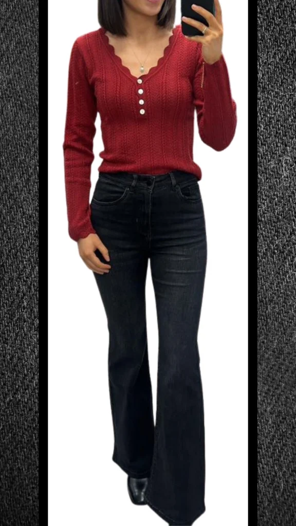 A cozy red ribbed knit top with a scalloped neckline and button details complements sleek black high-waisted flared jeans, creating a balanced silhouette perfect for winter. The outfit is enhanced by a polished, fitted appearance and subtle texture, while black ankle boots add a refined touch, making it suitable for cooler months.