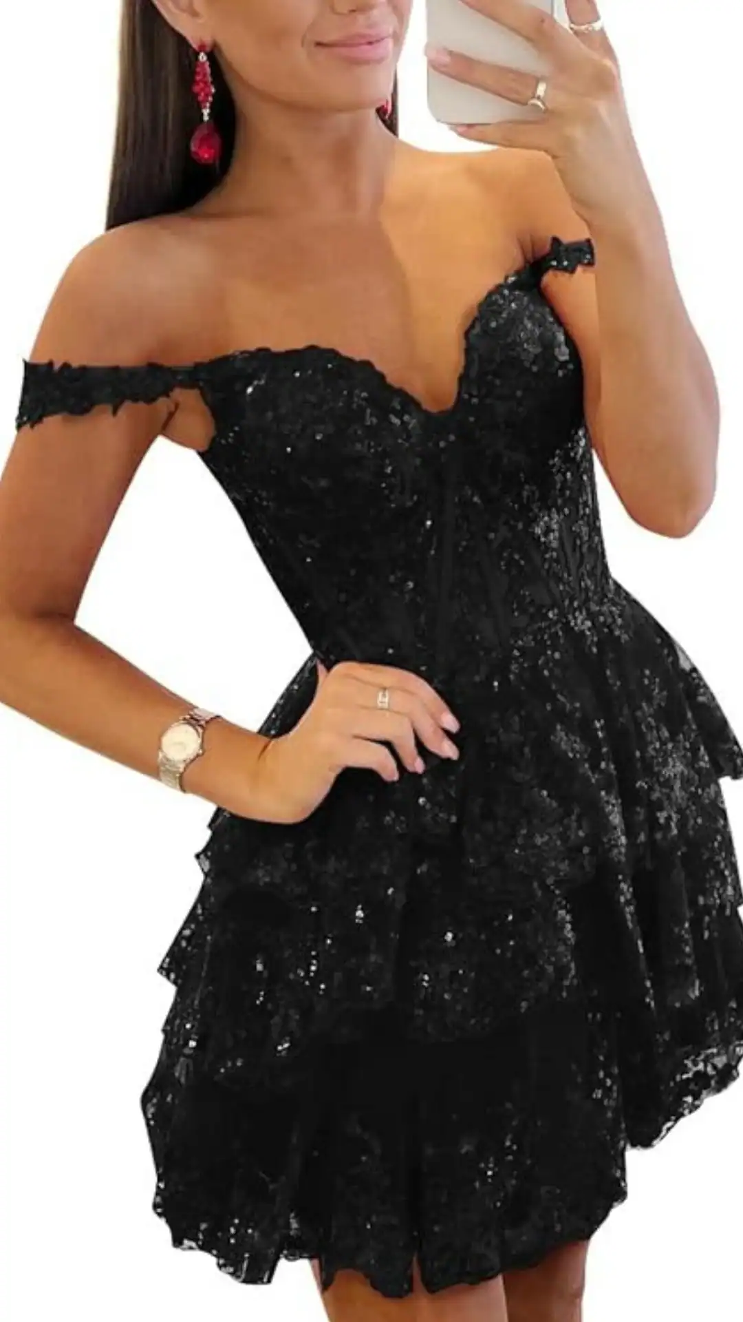 This black homecoming dress features an off-the-shoulder design with a fitted, corset-like bodice adorned in shimmering sequins, creating a glamorous, festive look. The tiered, voluminous skirt adds playful movement, making it perfect for a formal event like homecoming, appealing to teenage girls who desire a bold and chic style.