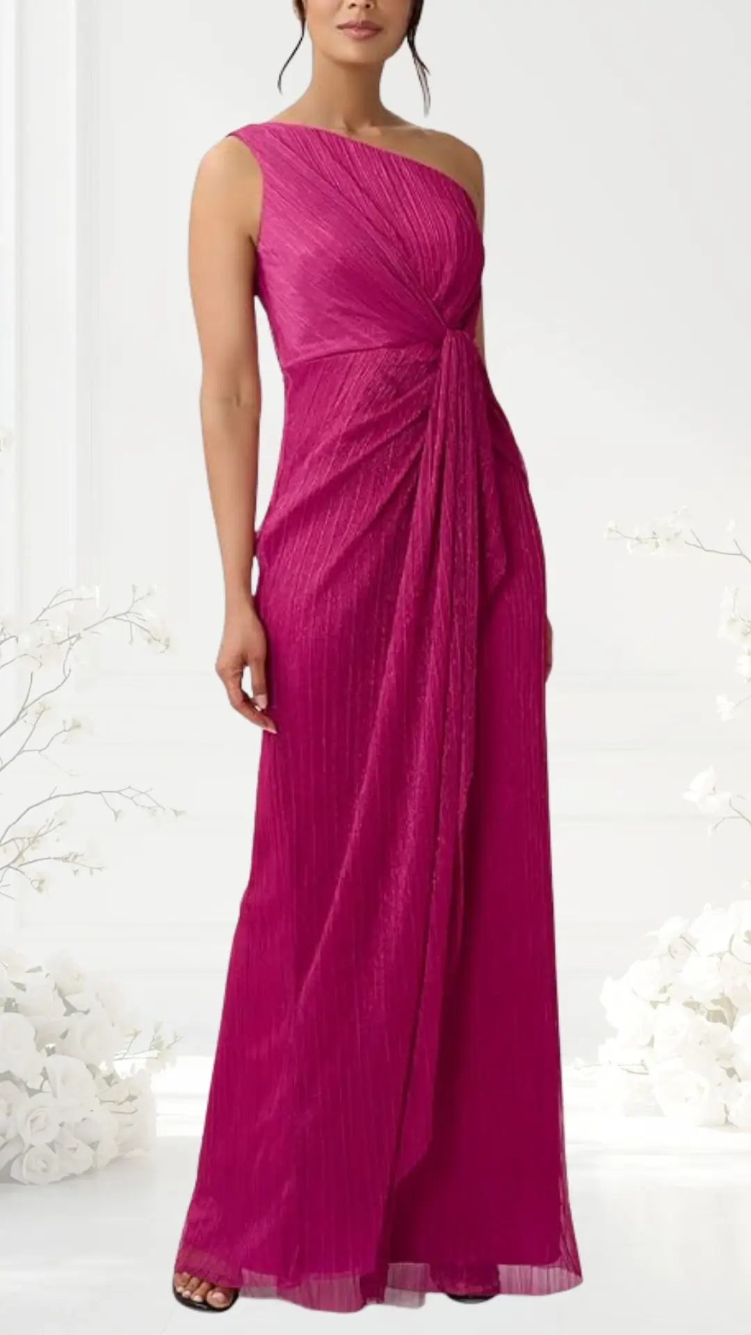 A sleek, one-shoulder gown in a vibrant fuchsia hue features a twist detail at the waist that creates elegant draping down to the floor. The fabric has a subtle sheen and delicate vertical pleats, enhancing its sophisticated appearance. The dress is complemented by a flowing silhouette, perfect for a black-tie event.