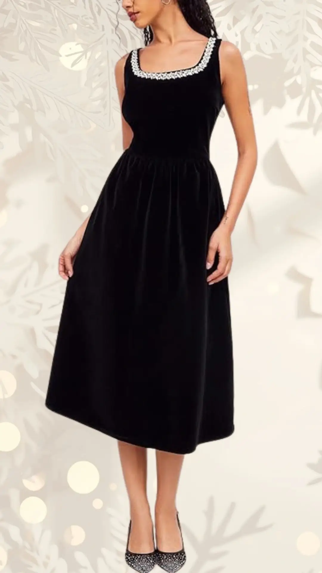 A black velvet wedding guest dress features a fitted bodice with a square neckline adorned with decorative embellishments. The skirt flows gently to a midi length, highlighting an elegant silhouette, complemented by sparkling black heels.