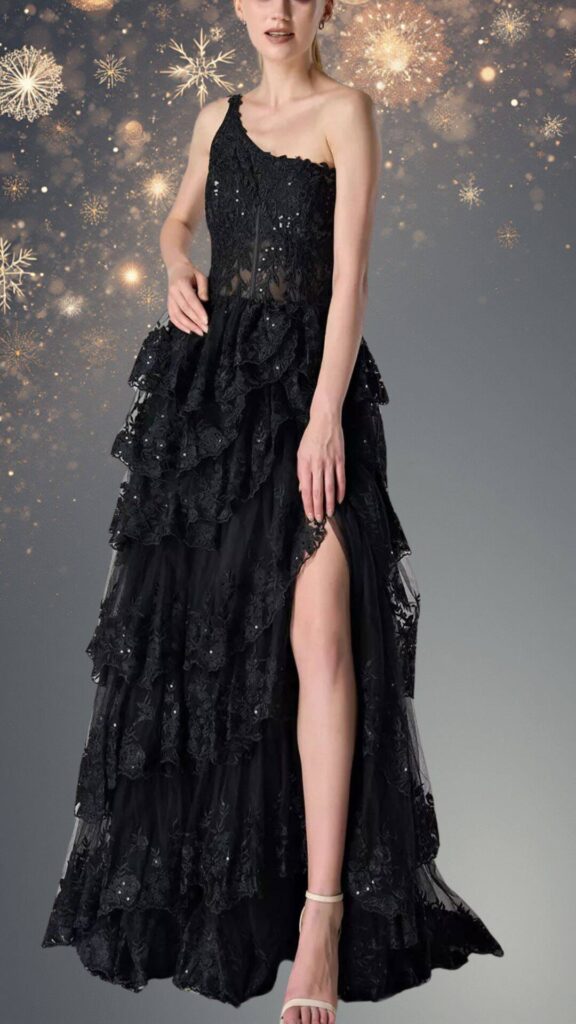 This elegant black winter formal dress features a one-shoulder design and a fitted bodice adorned with intricate lace and subtle beadwork. The skirt flows gracefully with layered ruffles, showcasing a thigh-high slit for added allure and movement, making it a stunning choice for any formal occasion.