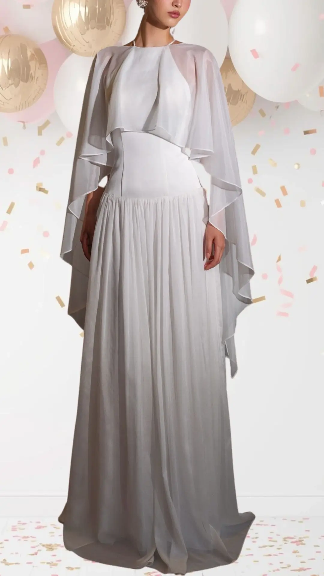 The outfit features a flowing white gown with a fitted bodice and a full, pleated skirt, exuding an elegant yet playful vibe. It is complemented by a translucent cape that drapes gracefully over the shoulders, while the soft fabric and delicate sheer textures create a whimsical touch. The simple neckline enhances the refined aesthetics, making it perfect for a celebratory occasion like a bridal shower.