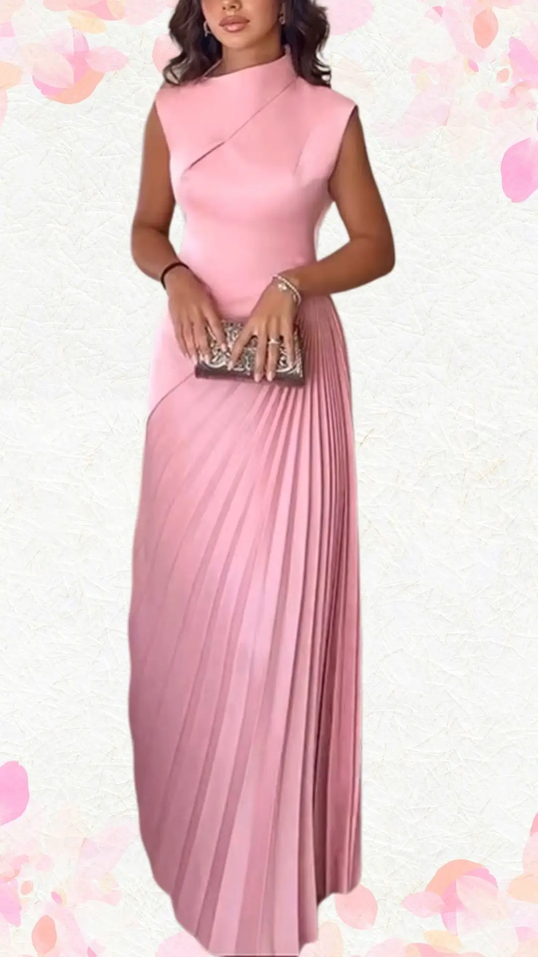 The outfit features a sleek, sleeveless, blush pink gown with a high neckline and an elegant wrap design. The dress is enhanced with vertical pleats that cascade gracefully from the waist, adding movement and texture, while its soft fabric offers a subtle sheen, making it suitable for a celebratory occasion. A metallic clutch complements the look, providing a touch of fun without feeling overly casual.