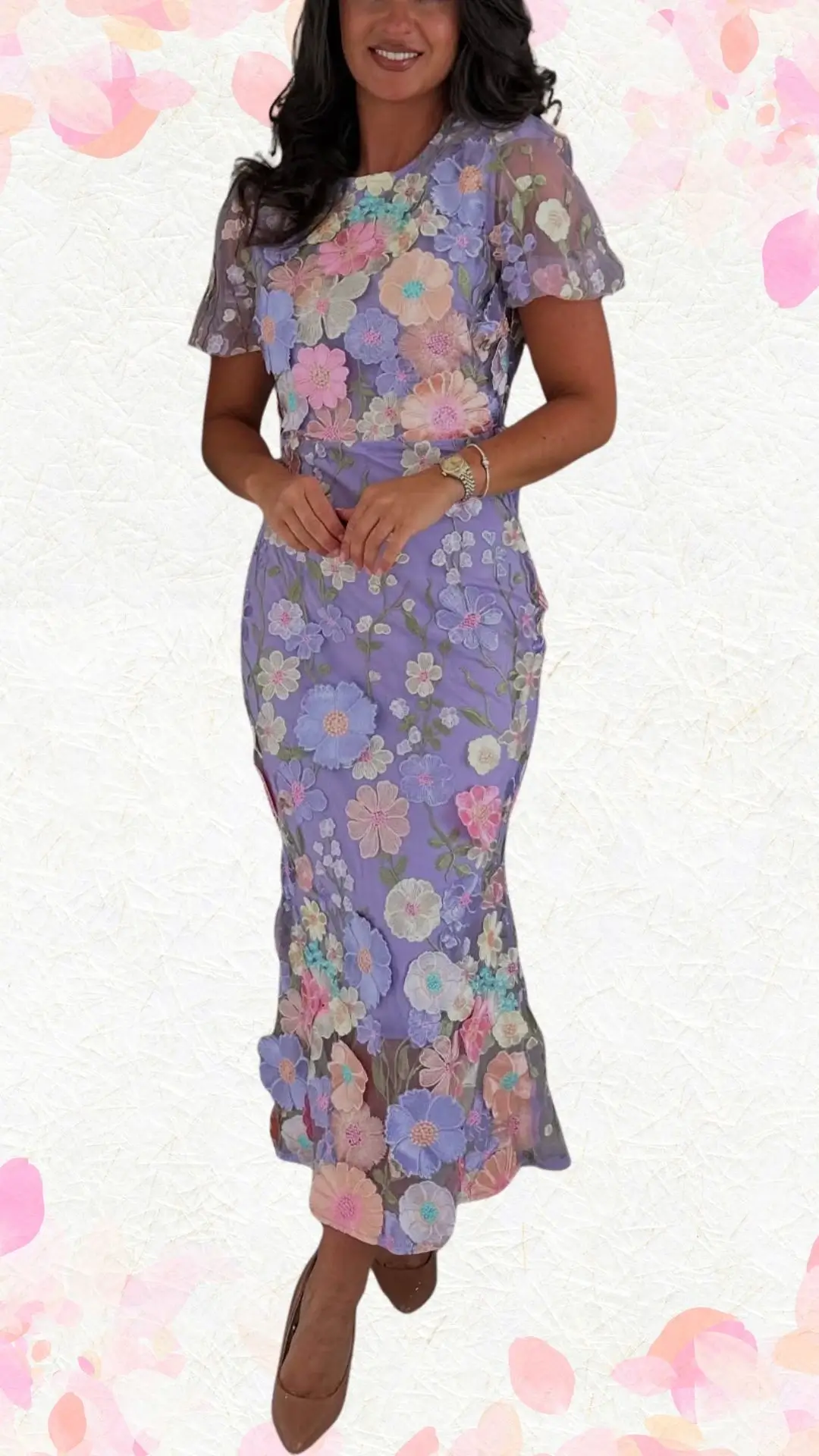 The outfit features a fitted lavender dress adorned with intricate floral embroidery in soft pastel shades, creating a whimsical yet elegant look. It has short, fluttery sleeves and a scoop neckline, enhancing its playful vibe while maintaining a polished silhouette, complemented by a subtle ruffled hem. The overall effect is perfectly suitable for a bridal shower, blending festivity with refined style.