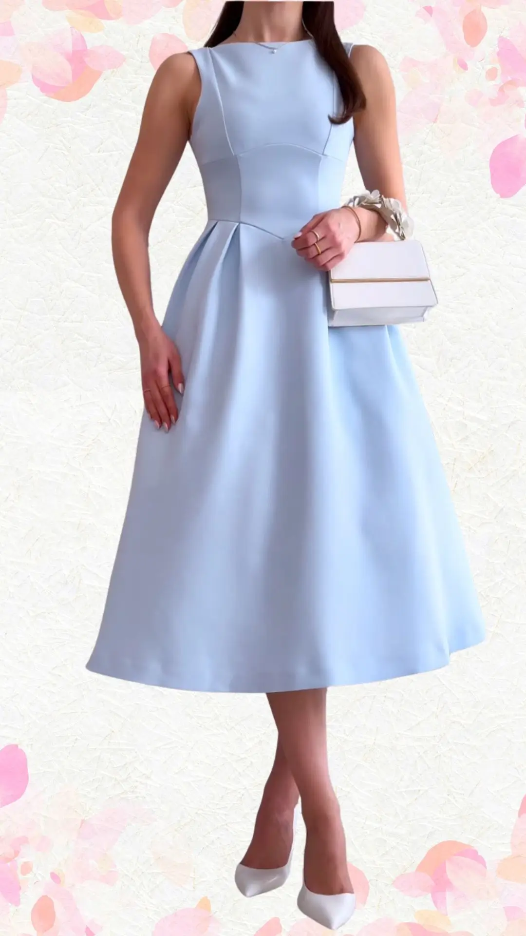 The outfit features a sleeveless, knee-length dress in a soft, pastel blue fabric with a smooth texture. It boasts a flattering, structured bodice with subtle pleats, and a classic round neckline, paired with elegant white heels and a chic white handbag adorned with a delicate floral detail, striking a perfect balance between elevated style and playful sophistication.