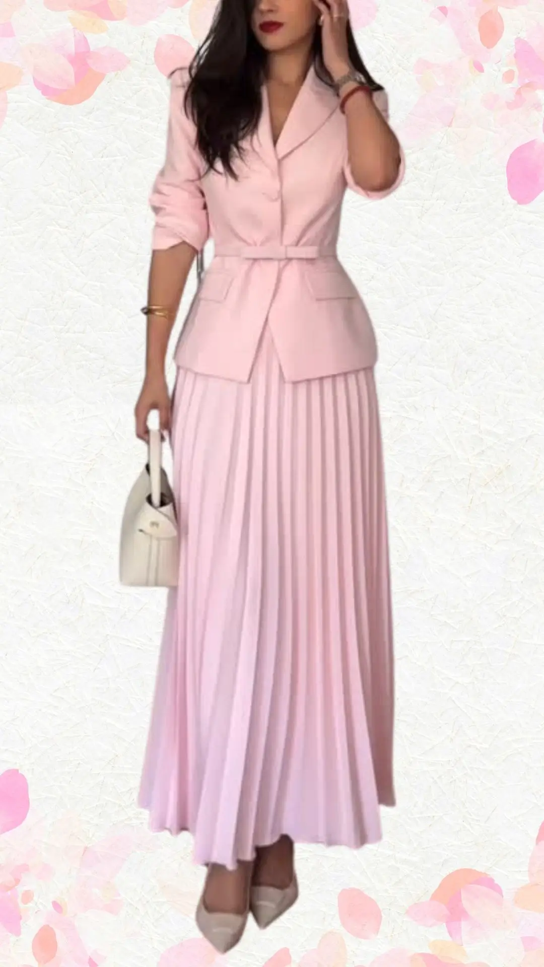 The outfit features a light pink, tailored dress with a fitted bodice and a flared, pleated skirt, creating a playful yet elegant silhouette. It has three-quarter length sleeves and a classic notch lapel neckline, all enhanced by a matching belt that accentuates the waist. A polished touch is added with pearl accessories, making it suitable for a bridal shower celebration while maintaining a balance between formal and whimsical.