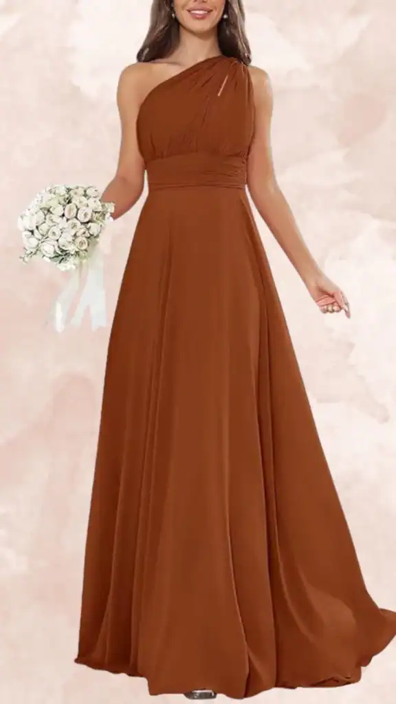 This brown bridesmaid dress features a one-shoulder neckline and a fitted waist that smoothly transitions into a flowing, floor-length skirt. The fabric drapes elegantly, adding softness to the design, while subtle gathering at the shoulder creates visual interest. The rich, deep brown color provides a warm and sophisticated look suitable for a variety of wedding themes.