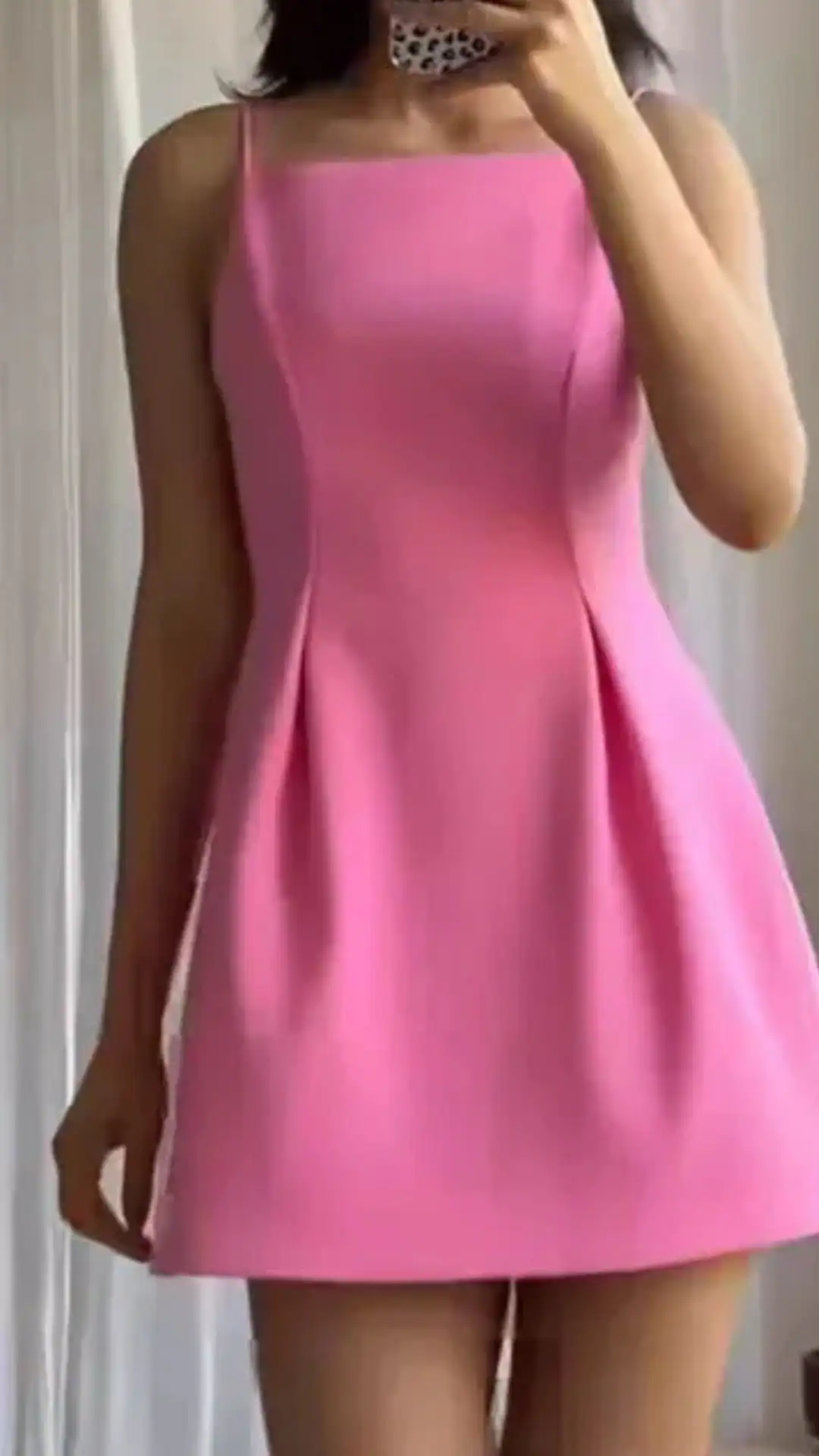 This bright, bubblegum pink homecoming dress features a sleek A-line silhouette with a fitted bodice and delicate spaghetti straps, offering a playful yet structured appearance. Crafted from a smooth, lightweight fabric with minimal texture, it is designed for fashion-forward teenage girls, exuding a trendy and youthful vibe perfect for formal events or school dances.