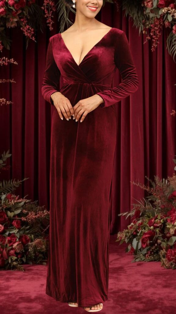 This elegant burgundy bridesmaid dress features a deep V-neckline and long sleeves, showcasing a soft, luxurious velvet texture. The gown has a flattering fitted silhouette with a subtle gathered waist, and it flows gracefully to the floor, creating a timeless and sophisticated look perfect for formal occasions.