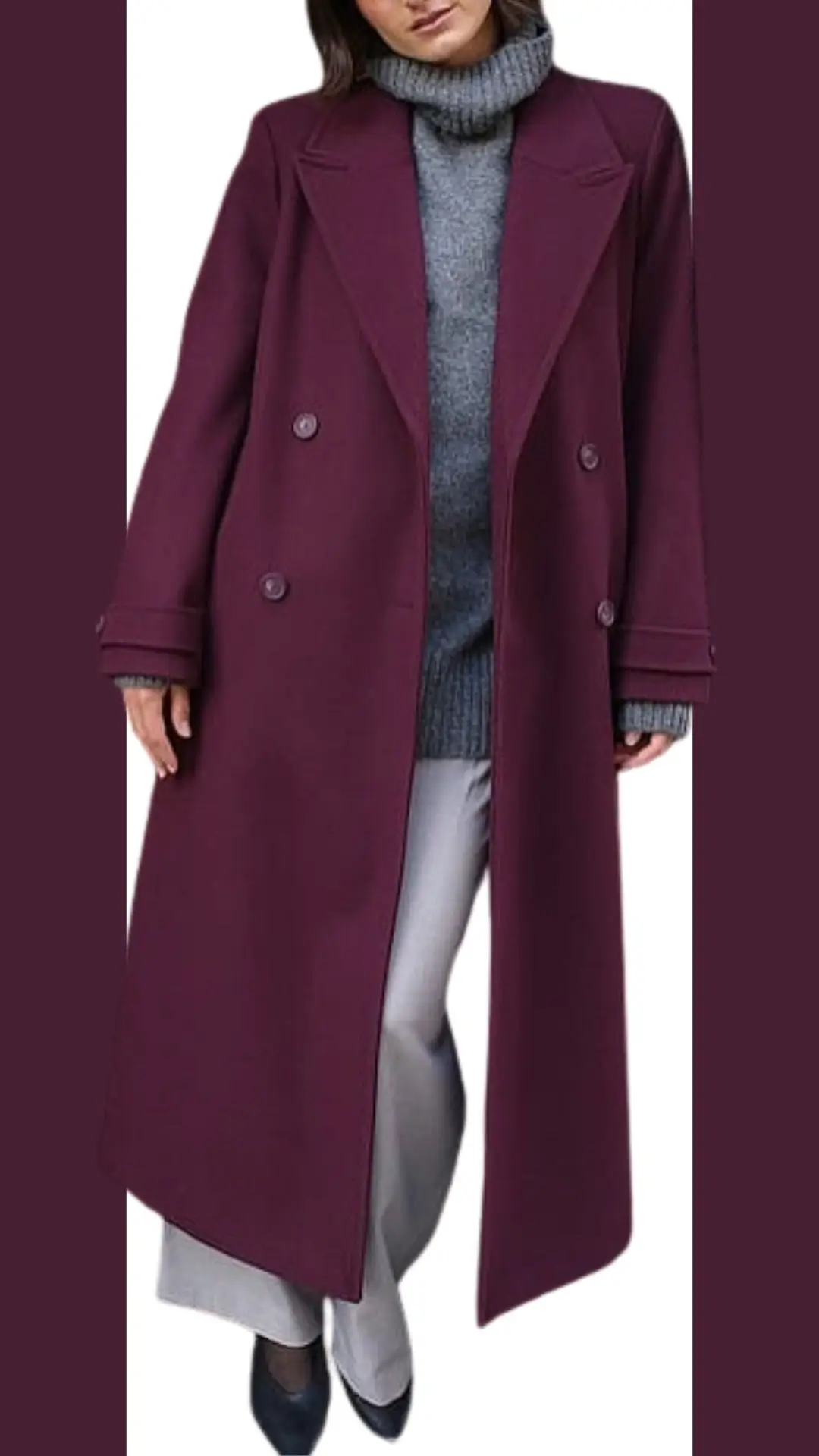 A long, burgundy coat featuring a double-breasted design with large buttons and wide lapels drapes elegantly over a soft, gray turtleneck sweater. The outfit is paired with tailored light gray trousers and sleek black heels, creating a sophisticated and modern look. Textures combine warmth from the knit sweater and smoothness from the coat, highlighting the rich color contrast.