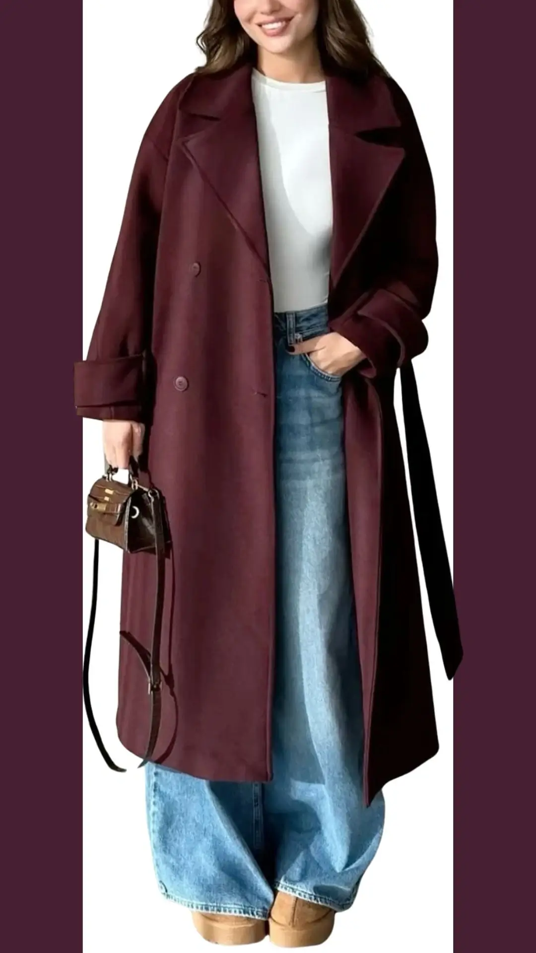 The outfit features a long, double-breasted burgundy coat made from a soft, textured fabric that exudes elegance. Underneath, a fitted white top contrasts with high-waisted, wide-leg blue jeans, complemented by tan ankle boots for a polished look. A small, stylish handbag adds a finishing touch to this chic ensemble.