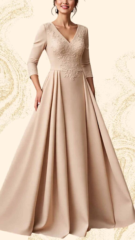 Elegant champagne mother of the bride dress featuring a flattering V-neckline and three-quarter sleeves. The gown flows to a full-length skirt, accentuated by delicate embroidery along the bodice, creating a timeless and sophisticated look. Crafted from a smooth fabric, it offers both comfort and style for a special occasion.