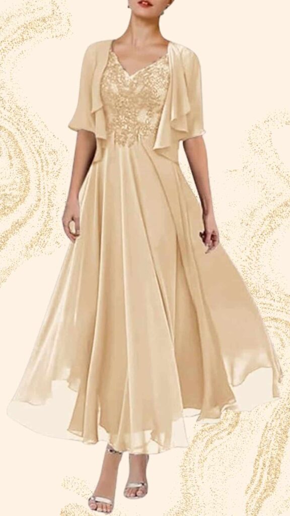 Champagne-colored mother of the bride dress featuring a flowing full-length skirt and a flattering A-line silhouette. It has a V-neckline adorned with intricate beading, short flutter sleeves for added elegance, and a lightweight, silky texture that gently drapes for a graceful look. A matching shawl complements the dress, enhancing its sophistication.