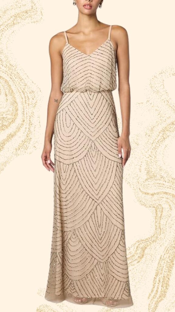 This elegant champagne mother of the bride dress features a floor-length design with a soft, flowing silhouette. It has a V-neckline and delicate spaghetti straps, adorned with intricate beadwork creating a wave pattern that enhances its classy aesthetic. The lightweight fabric drapes beautifully, offering both comfort and sophistication for a special occasion.
