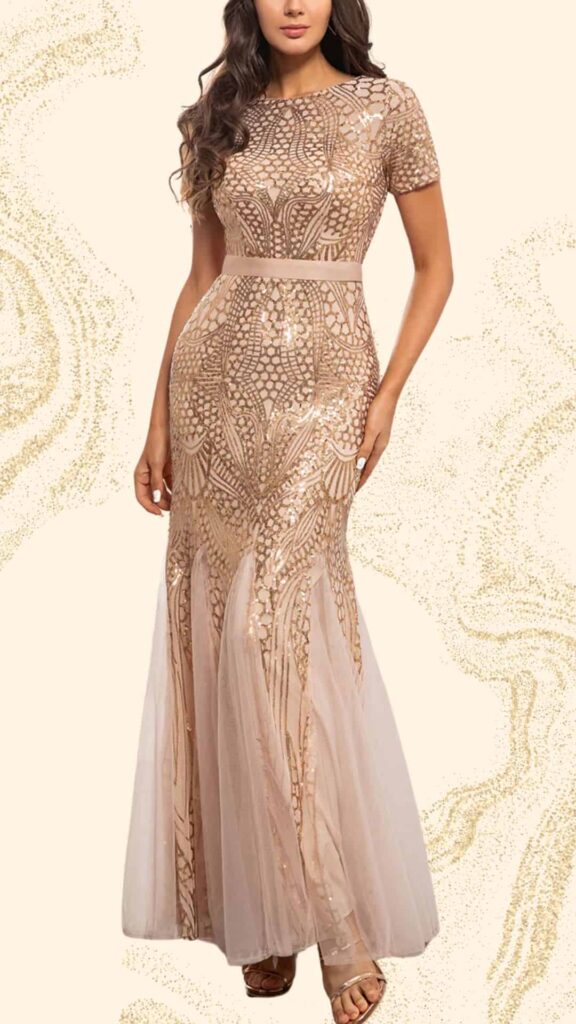 This elegant champagne mother-of-the-bride dress features a fitted silhouette with a floor-length design, adorned with intricate sequin detailing that creates a delicate lace-like pattern. The gown has a modest round neckline and short sleeves, topped off with a flowing tulle overlay that adds softness to the overall look. A subtle waistband accentuates the figure, making it a perfect choice for a classy wedding attire.