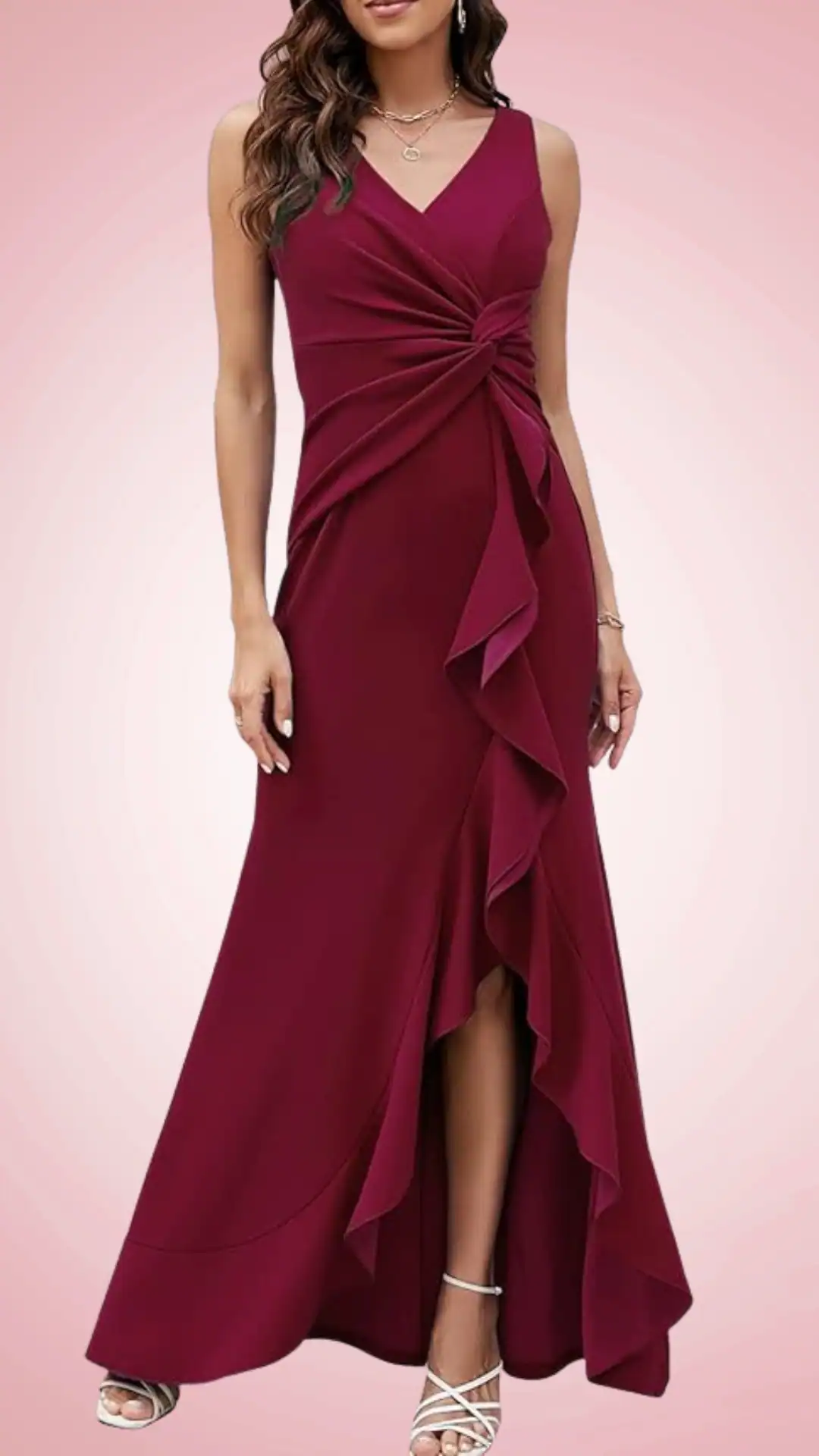 Deep burgundy homecoming dress with fitted silhouette, twist front design, and flowing ruffled detail