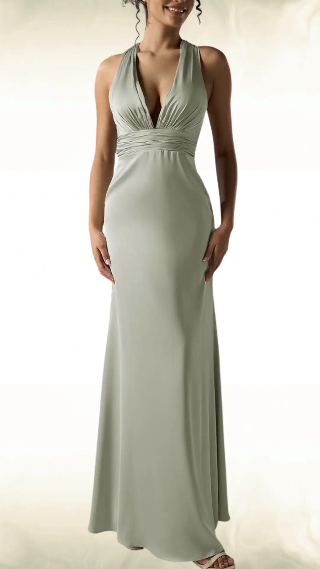 Elegant sage green dress with a plunging halter neckline, gathered waist, and floor-length skirt, perfect for formal fall weddings.