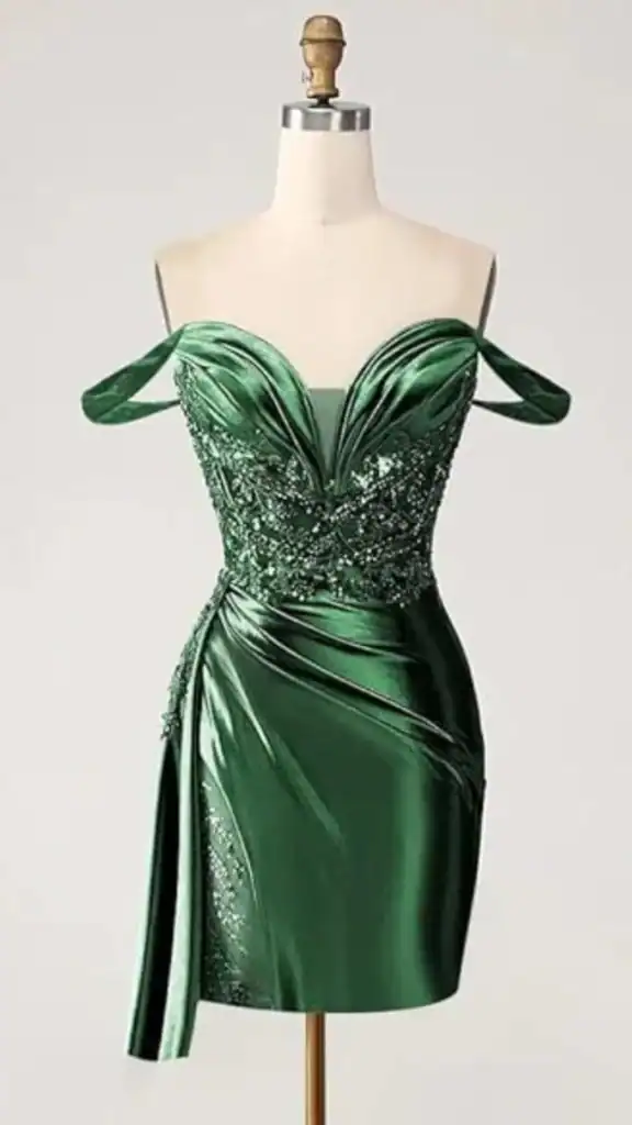 This emerald green homecoming dress features a fitted bodice with elegant off-shoulder straps and intricate beading embellishments, complemented by a sleek, draped skirt with a side slit for added flair. The glossy satin fabric provides a luxurious texture, creating a bold and glamorous look ideal for teenage girls attending formal events or school dances.