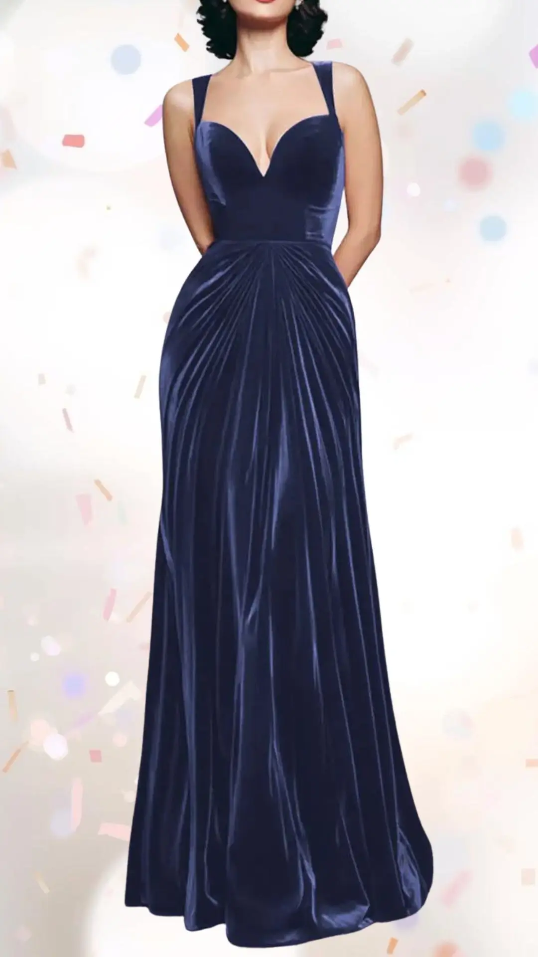 The outfit features a deep navy velvet gown with a fitted bodice and a plunging V-neckline, enhancing elegance while maintaining a playful appeal. It has wide shoulder straps and pleats that cascade down the skirt, creating a flowy silhouette that is both sophisticated and whimsical. The rich texture of the fabric adds depth, making it a perfect choice for a celebratory occasion.