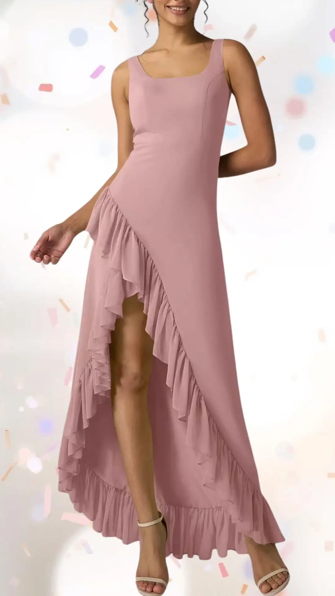 A flowing, light pink maxi dress features a square neckline and wide straps, enhanced by playful ruffles cascading along one side and the hemline. The fabric offers a soft texture, striking a balance between elegance and fun, perfect for an engagement party. Paired with subtle strappy heels, this outfit exudes a whimsical charm suitable for celebration.