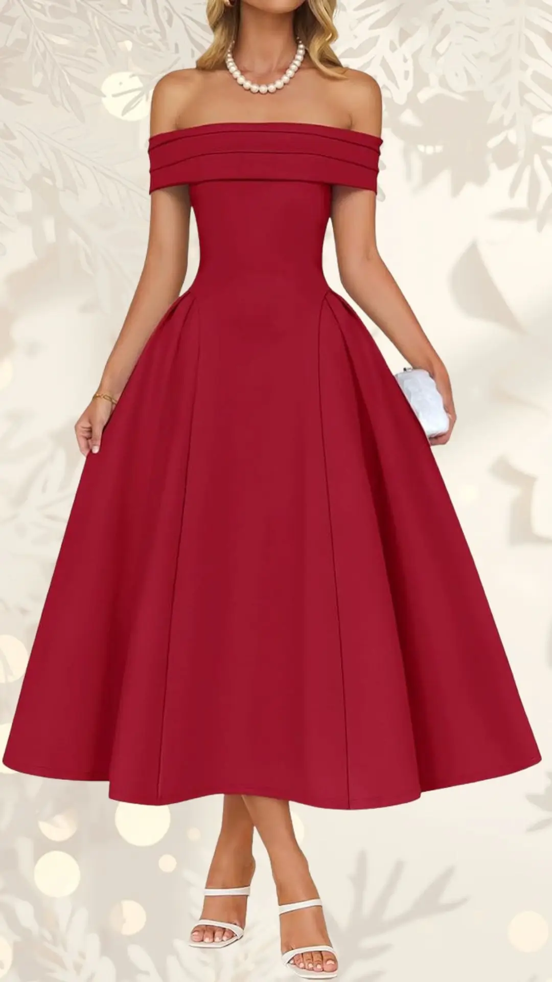The image features a stunning off-the-shoulder wedding guest dress in a rich burgundy hue, tailored with a fitted bodice and a full, flared skirt that falls gracefully to mid-calf. The model accessorizes with a string of pearls and wears white strappy heels, complementing the elegant silhouette of the dress. The background is softly blurred with festive elements, enhancing the dress's appeal.
