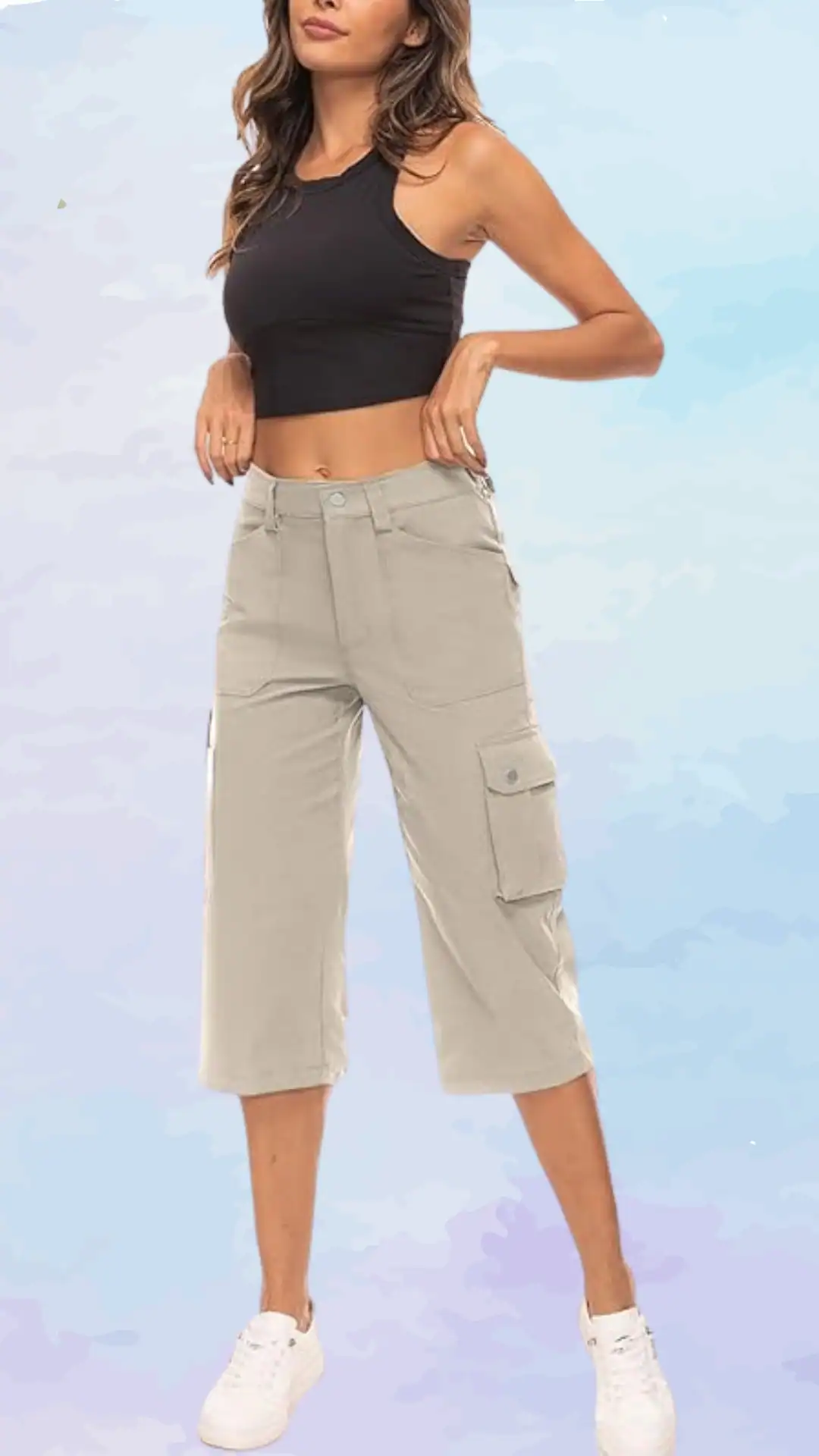 This outfit features a fitted black crop top paired with lightweight, light beige cargo pants that have a relaxed fit and practical side pockets, creating a casual yet stylish look. The overall vibe is laid-back and modern, perfect for a casual outing or summer activities.