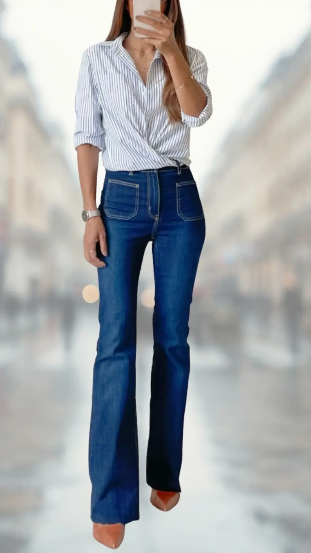 The outfit features high-waisted, tight-fitting flare jeans in a deep blue denim, complemented by a lightweight, long-sleeved shirt adorned with white stripes and a relaxed wrap style. Paired with stylish nude high-heeled shoes, this look exudes a casual yet polished vibe, combining soft textures and a contemporary silhouette. The overall ensemble highlights a blend of classic and modern fashion elements.