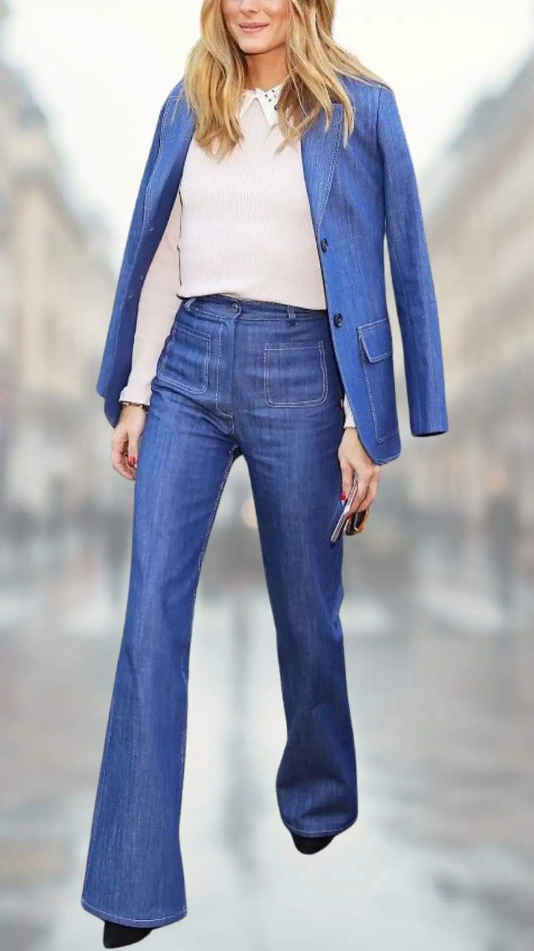The outfit features a pair of fitted flare jeans in medium blue denim, complemented by a light cream ribbed long-sleeve top with a subtle collar detail. A tailored blue blazer adds a sophisticated touch, while sleek black ankle boots complete the look, enhancing its chic and polished appeal.