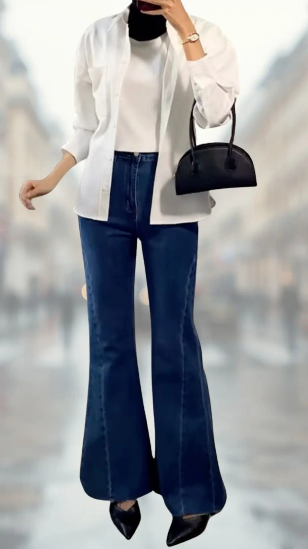 The outfit features a classic white button-up shirt layered over a fitted black turtleneck and paired with dark blue flared jeans, emphasizing a stylish silhouette. The jeans have a soft denim texture, while the shoes are pointed black heels that add elegance. Accessories include a small black handbag, completing the chic look with a contemporary flair.