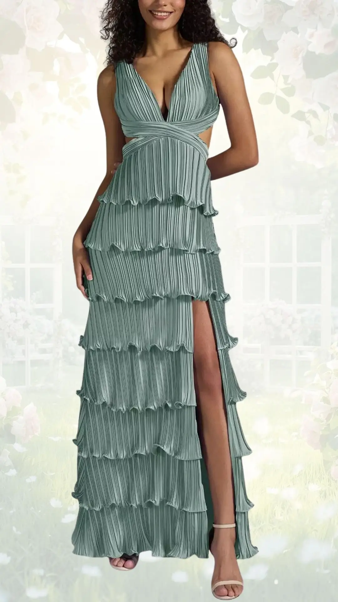 A flowy, mint green wedding guest dress features a deep V-neckline and cut-out sides, accentuated by ruffled tiers cascading down the skirt. The design includes a thigh-high split on one side, adding a touch of allure, paired with elegantly strappy heels. The dress falls gracefully to the floor, perfect for a spring garden celebration.