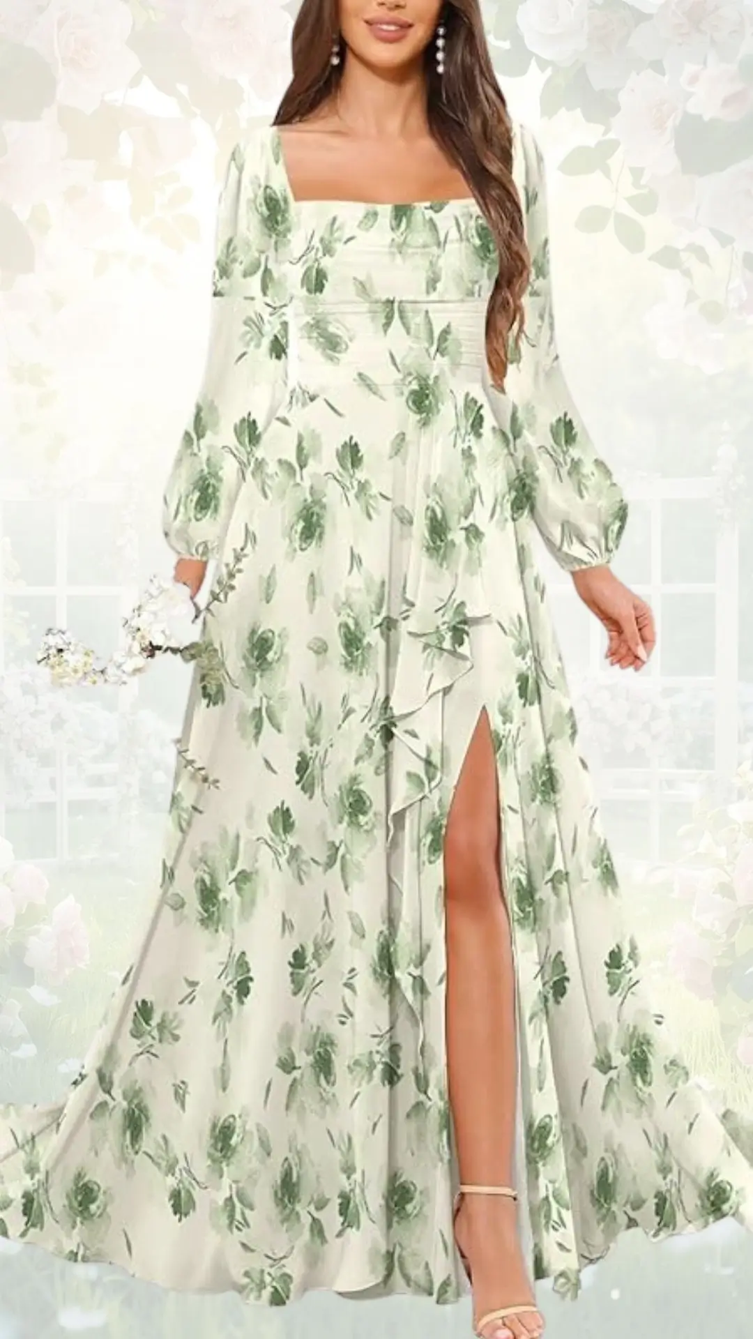 A flowing, long-sleeved dress features a light cream base adorned with delicate green floral patterns. The dress has a square neckline and a thigh-high slit on one side, adding a touch of elegance. Complementing the look, the model holds a small bouquet of white flowers.