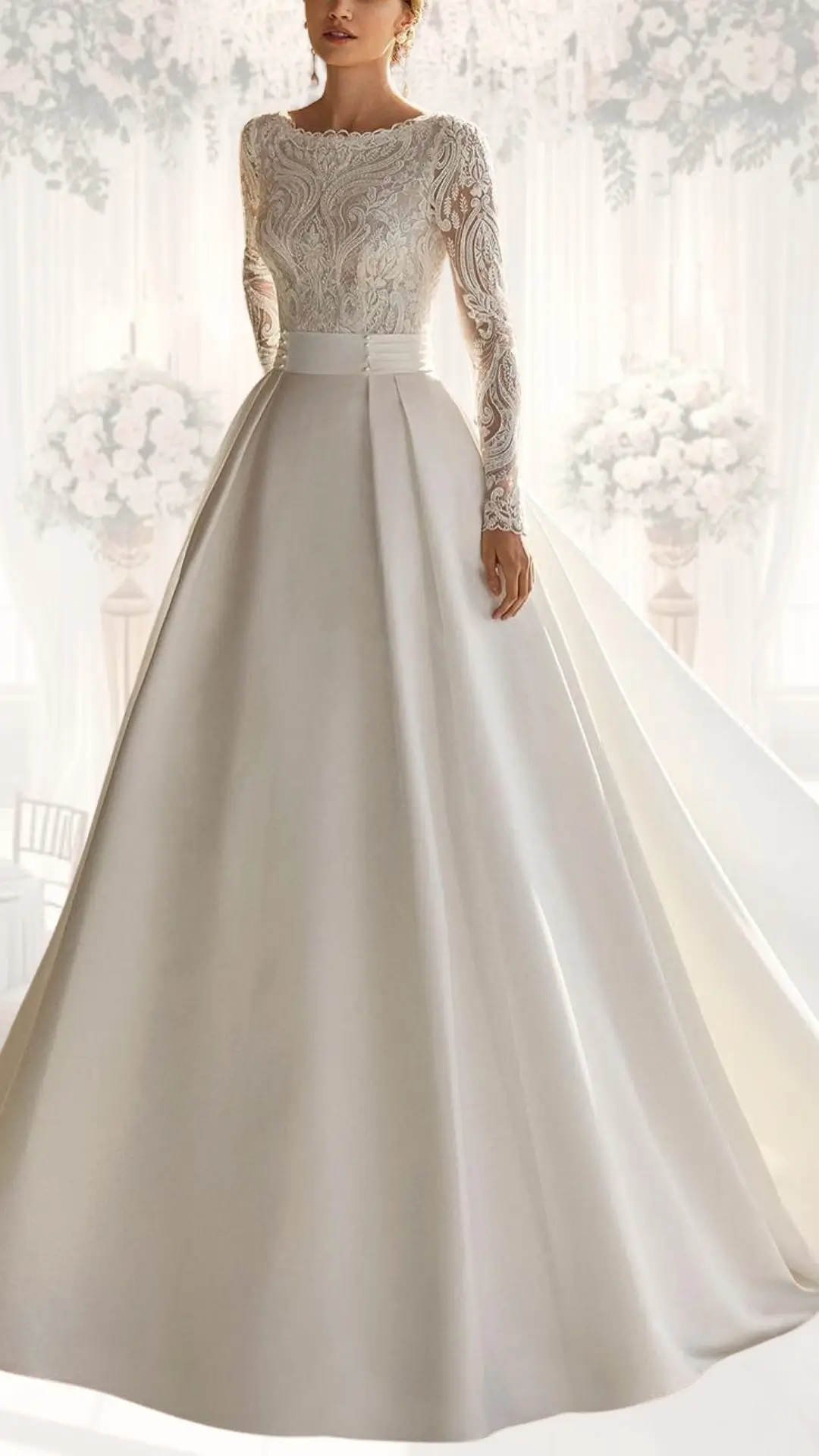 This high neck wedding gown features an intricately detailed lace bodice with long sleeves and a classic scalloped neckline, complemented by a flowing satin skirt that elegantly drapes to the floor. Its soft ivory shade enhances the vintage vibes, while the modest design and luxurious textures make it an ideal choice for a winter wedding. The fitted waist transitions beautifully into a full skirt, adding an extra touch of sophistication.