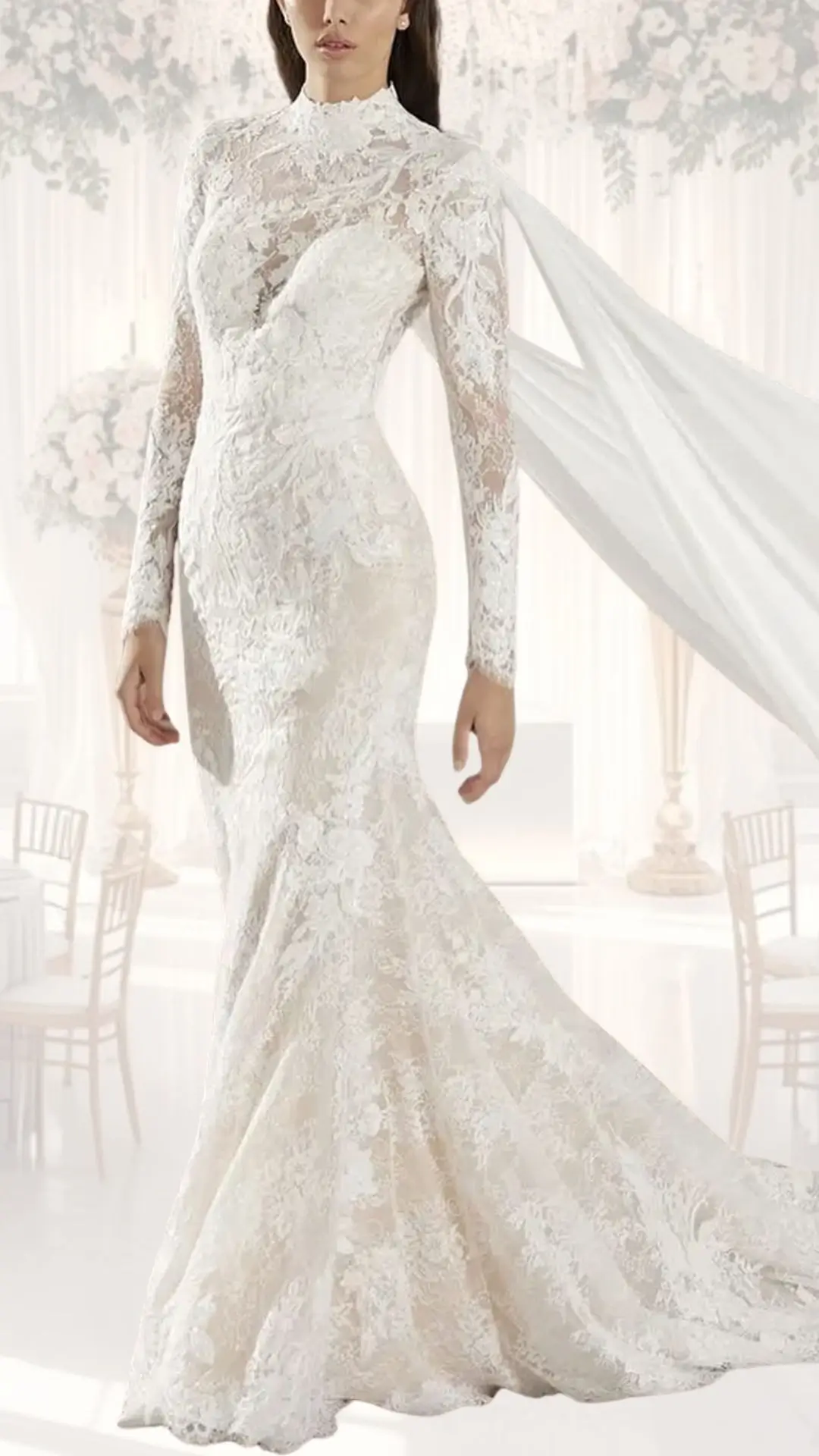 This high neck wedding gown features intricate lace detailing, with a fitted bodice and long, sheer sleeves for a modest yet elegant look. The gown's soft ivory shade complements the floral appliqué, while the flowing skirt trails behind, evoking vintage charm perfect for a winter wedding. The overall design combines classic sophistication with contemporary touches, ensuring a timeless appeal.