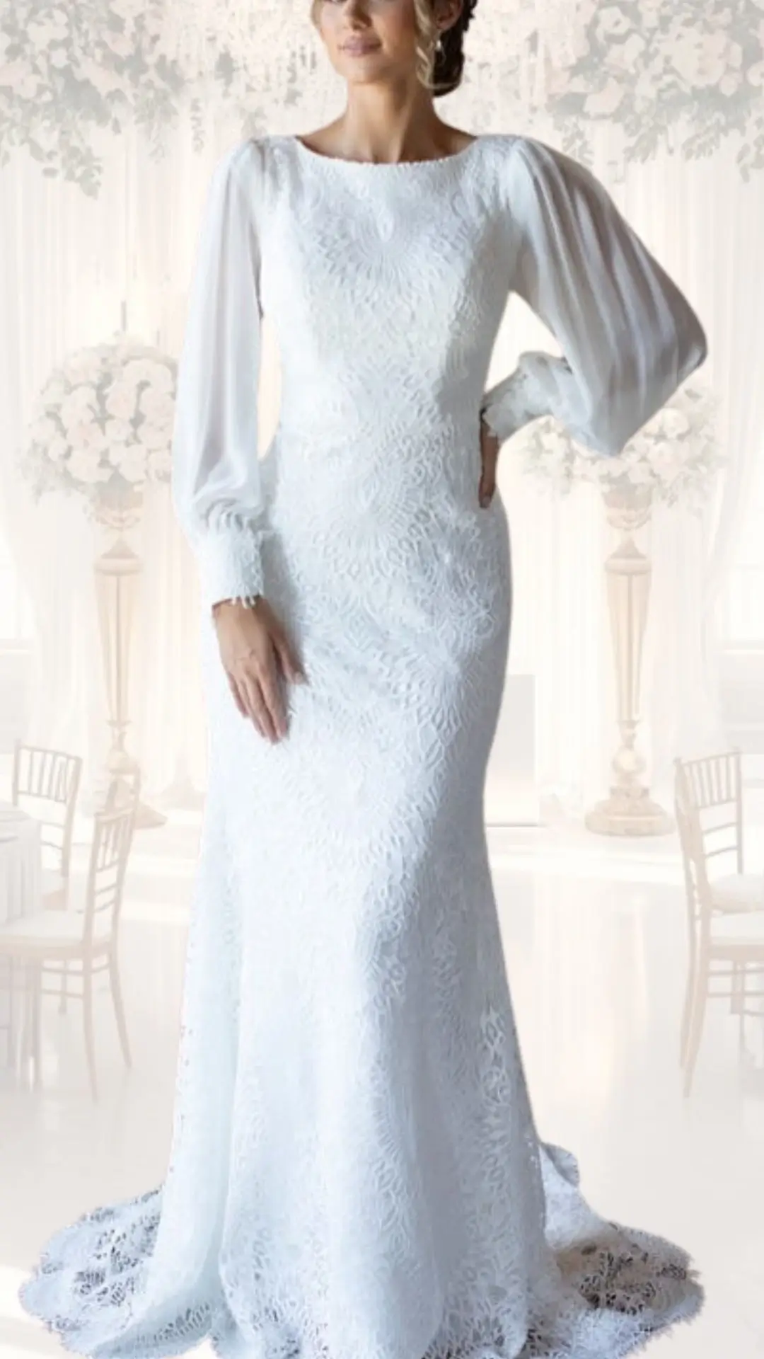 This high neck wedding gown features a delicate white lace fabric with intricate floral patterns, exuding a vintage elegance perfect for a winter wedding. The long, billowy sleeves and fitted silhouette enhance its modest style, while the softly flowing skirt with a subtle train adds to the overall sophistication. The dress's classic neckline and textured detailing make it a timeless choice for a chic and graceful bridal look.