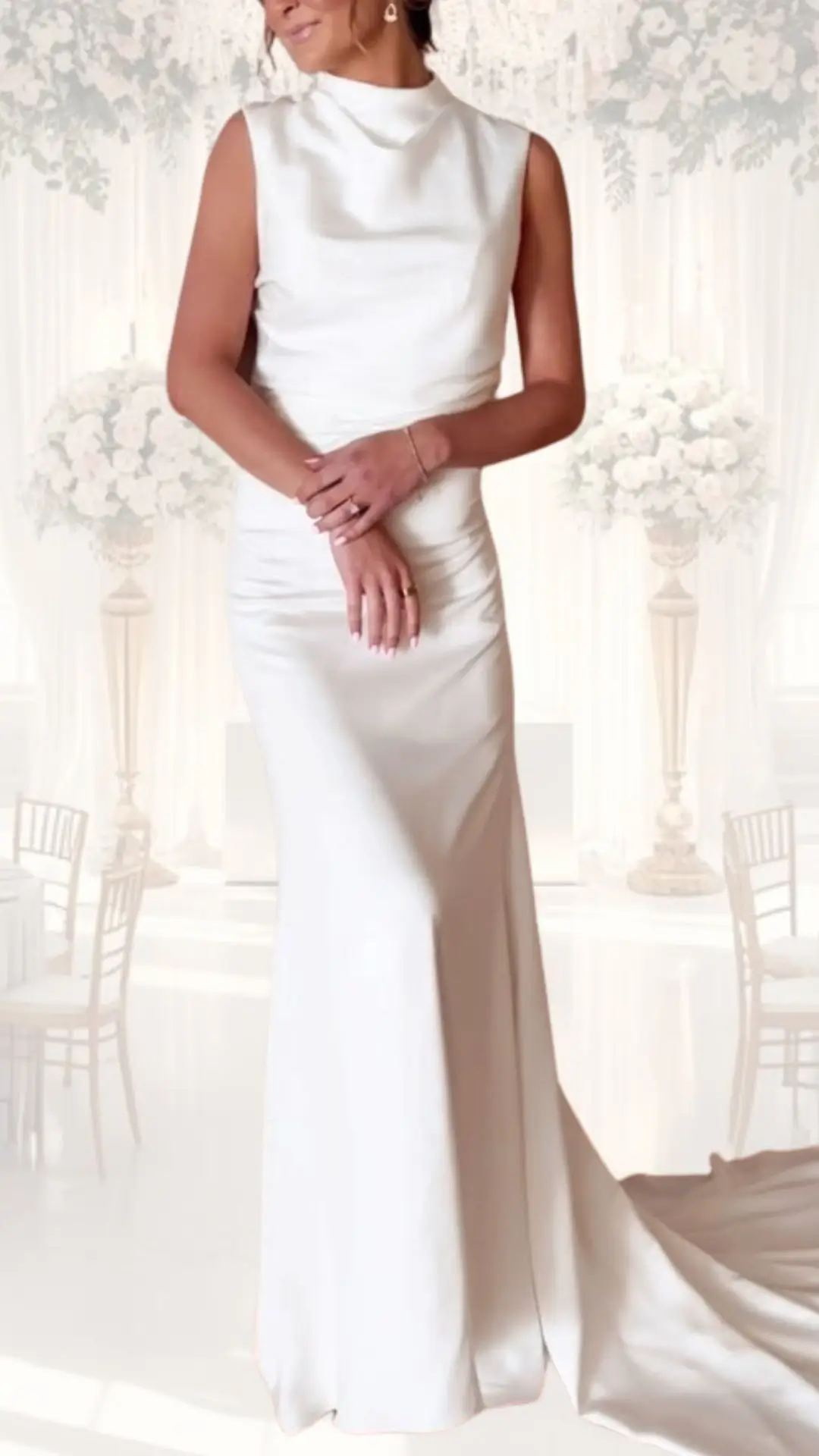 The high neck wedding dress features a sleek silhouette crafted from luxurious satin, exuding a soft shimmer in a classic ivory shade. The sleeveless design seamlessly flows into a fitted skirt, with gentle ruching at the waist enhancing its elegance, while the floor-length hem and subtle train evoke vintage bridal charm, making it an ideal choice for a winter wedding.