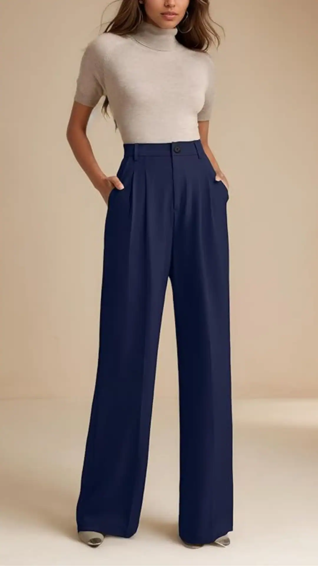 High-waisted navy trousers feature a wide-leg silhouette, crafted from a soft, matte fabric that offers comfort and elegance. The clean lines and tailored design create a minimalist vibe, making them suitable for both casual outings and more formal events.