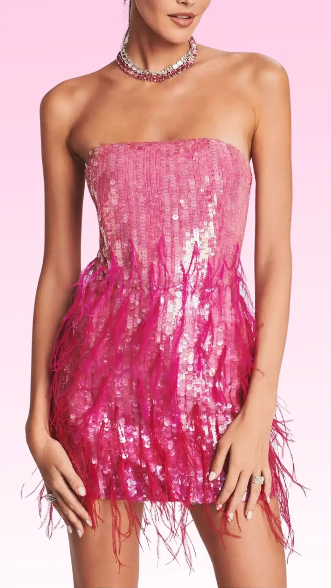 This vibrant, strapless mini dress features a bold hot pink fabric adorned with sequins, creating a dazzling, reflective texture. The design includes playful feather detailing at the hem, offering a flirty vibe perfect for homecoming or a fancy event, targeting trendy teenage girls seeking a fun and eye-catching look.
