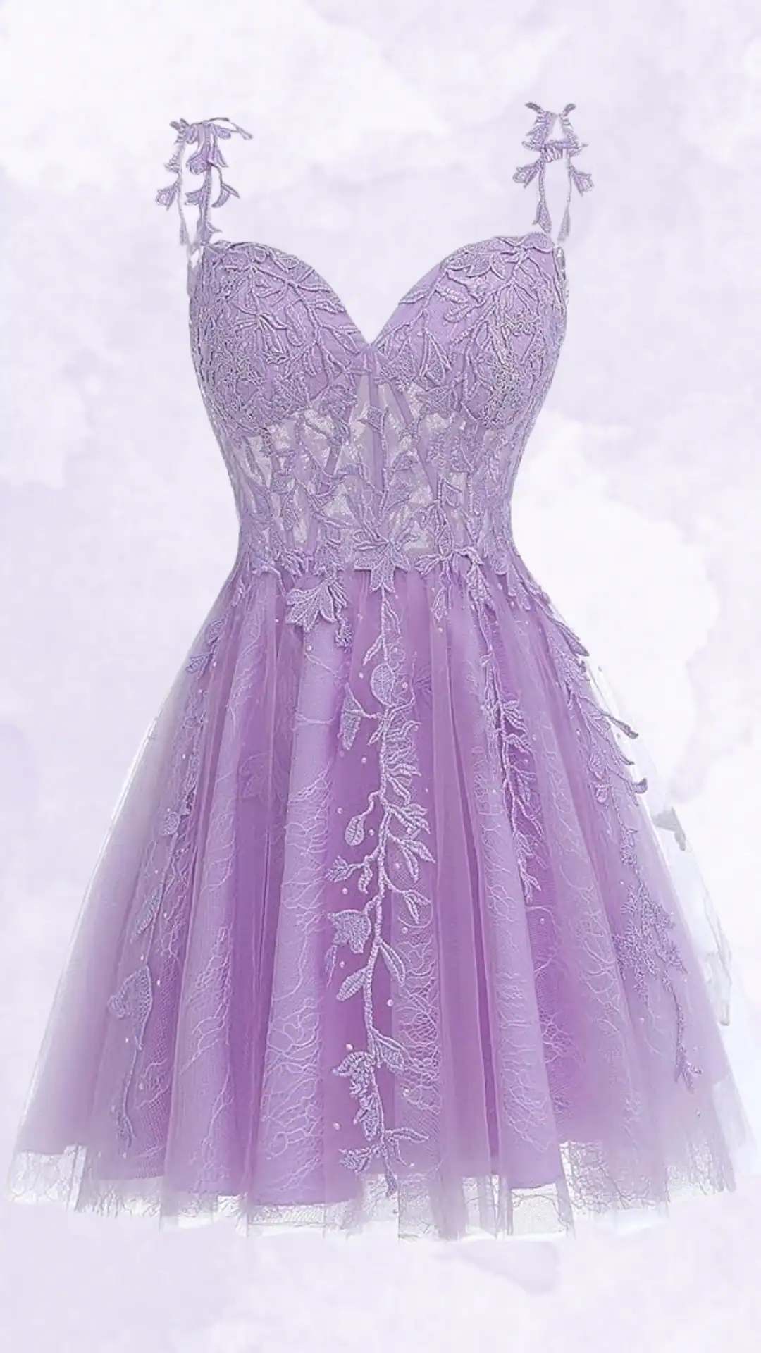 This captivating homecoming dress features a delicate lavender hue with intricate floral lace embroidery, creating a charming and ethereal aesthetic. The fitted bodice leads to a voluminous tulle skirt, making it a perfect choice for teen girls at formal events or school dances, embodying a romantic and whimsical vibe.