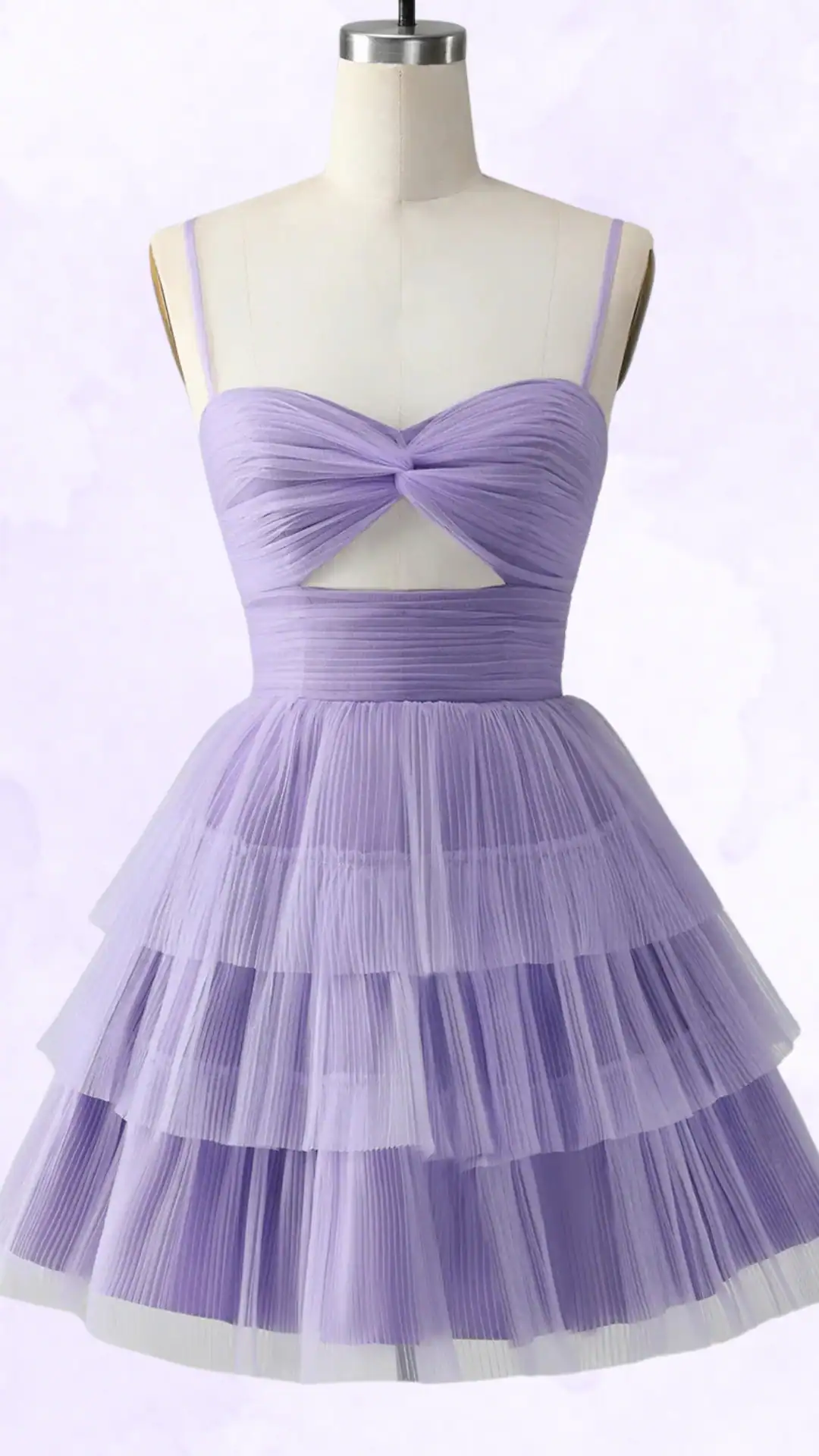 This playful homecoming dress features a lavender color with a soft, layered tulle skirt that creates an enchanting, voluminous effect. The fitted bodice is adorned with pleated details and a twist design that showcases a subtle cutout, making it a chic choice for teenage girls attending formal events or dances.